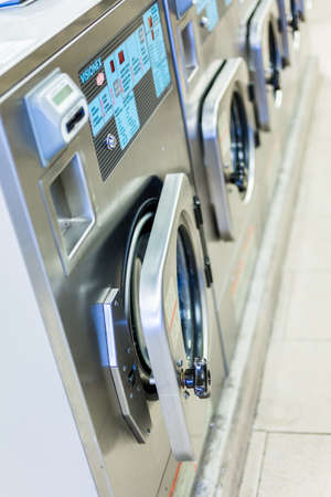 Industrial washing machines in a public laundry.の写真素材