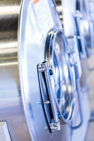 Industrial washing machines in a public laundry.の写真素材