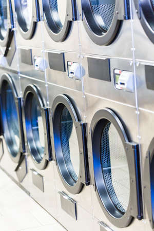 Industrial washing machines in a public laundry.の写真素材