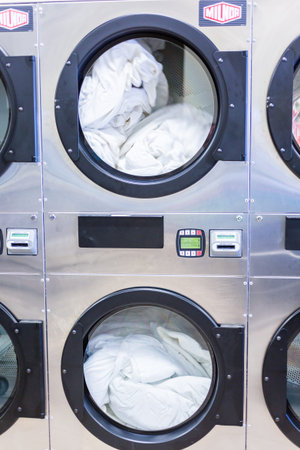Industrial washing machines in a public laundry.