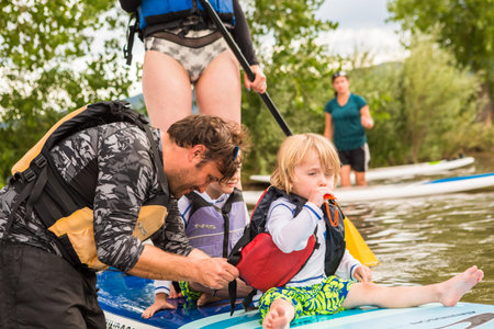 Denver, Colorado, USA-July 23, 2016. Recreational paddleboarding on small pond.