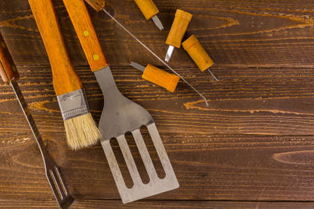 Stainless steel barbecue cooking set with wood handles.の写真素材