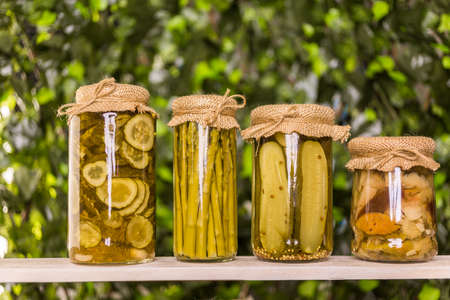 Homemade canned organic vegetables in glass jars.の写真素材