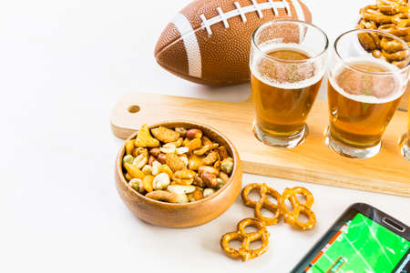 Draft beer with snaks at the football game party.の写真素材