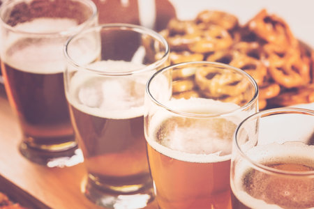 Draft beer with snaks at the football game party.の写真素材