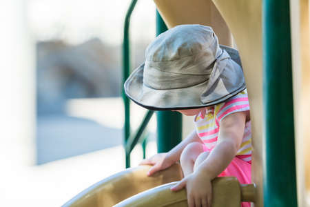Toddler playing at outdoor playground.の写真素材