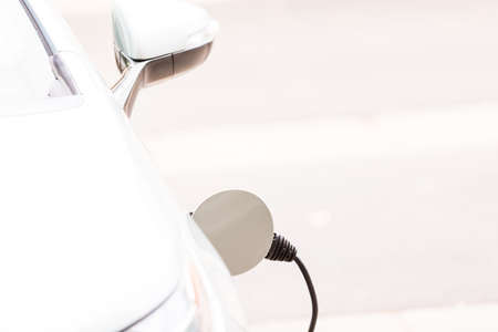 Charging electric car in residential garage.の写真素材