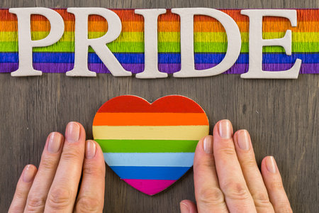 Rainbow Gay Pride sign on wood background.