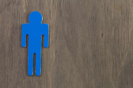 Male and female cutouts on wood background.の写真素材