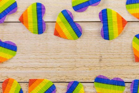 rainbow Gay Pride hearts on a wood background.の写真素材