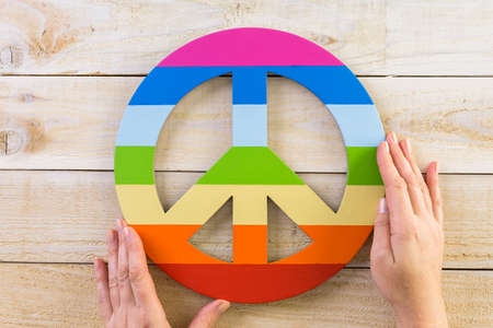 Rainbow Gay Pride Peace sign on wood background.の写真素材