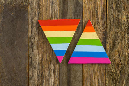 rainbow Gay Pride triangle sign on a wood background.の写真素材
