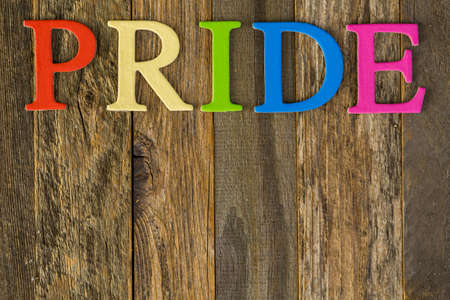 rainbow Gay Pride sign on a wood background.の写真素材