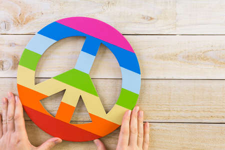 Rainbow Gay Pride Peace sign on wood background.の写真素材