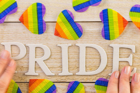 Rainbow Gay Pride sign on wood background.