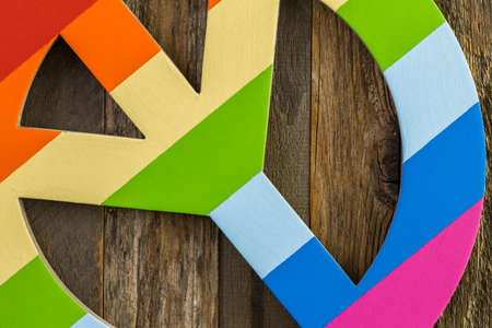 Rainbow Gay Pride peace sign on a wood backgroundの写真素材