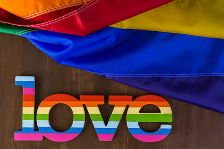 Rainbow Gay Pride Love sign on wood background.の写真素材