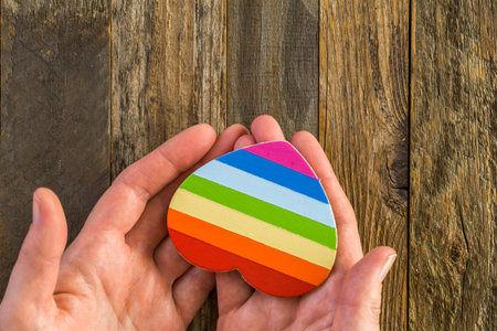 Rainbow Gay Pride heart sign on a wood backgroundの写真素材