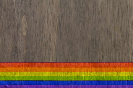 rainbow Gay Pride ribbon on a wood background.の写真素材
