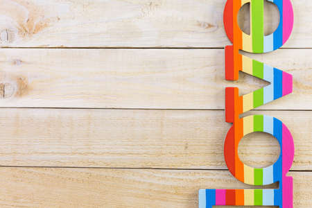 Rainbow Gay Pride Love sign on wood background.の写真素材