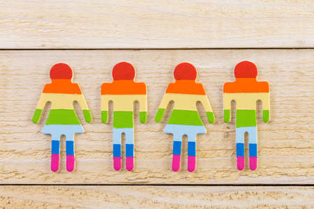 Rainbow Gay Pride male and female figures on wood background.の写真素材