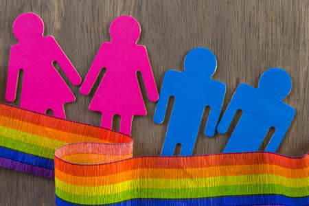 Rainbow Gay Pride male and female figures on wood background.の写真素材