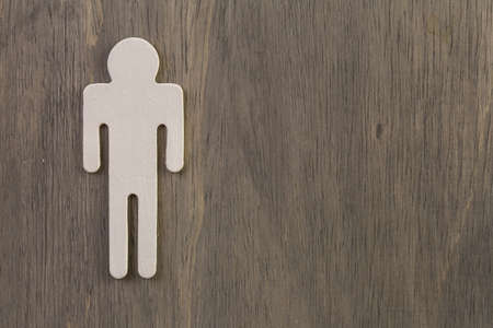 Male and female cutouts on wood background.の写真素材