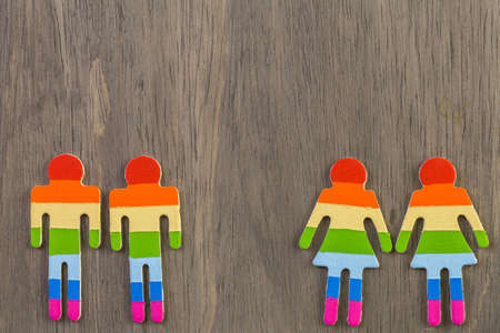 Rainbow Gay Pride male and female figures on wood background.の写真素材