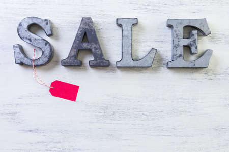 Tags with sale sign on wood board.の写真素材