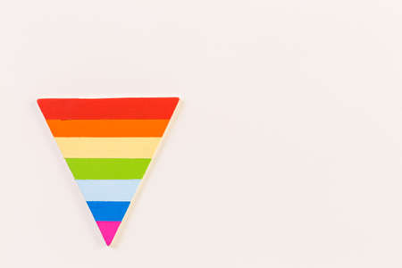 Rainbow Gay Pride triangle on a wood background.の写真素材