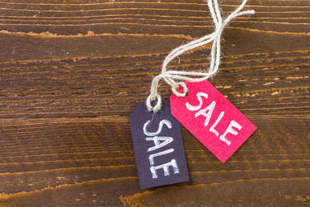 Tags with sale sign on wood board.の写真素材