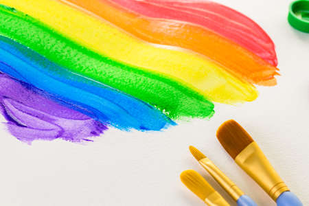 Painting Rainbow Gay Pride heart on a white paper.の写真素材