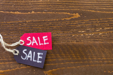 Tags with sale sign on wood board.の写真素材