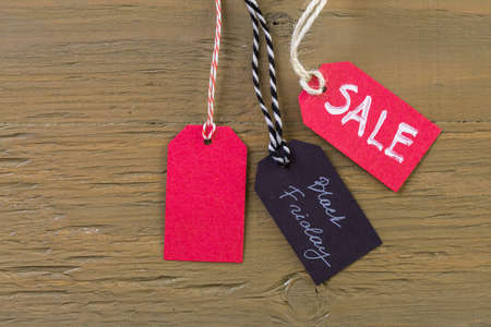 Tags with sale sign on wood board.の写真素材