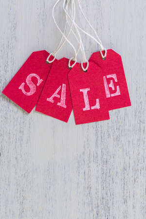 Tags with sale sign on wood board.の写真素材