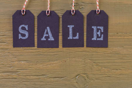 Tags with sale sign on wood board.の写真素材