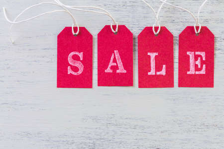 Tags with sale sign on wood board.の写真素材