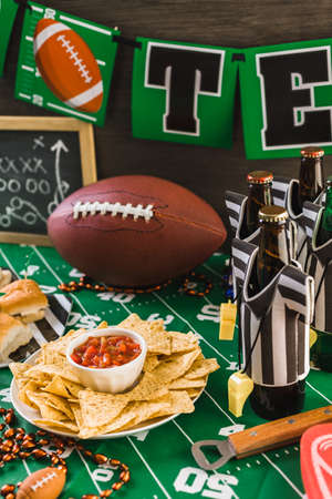 Game day football party table with beer, chips and salsa.の写真素材