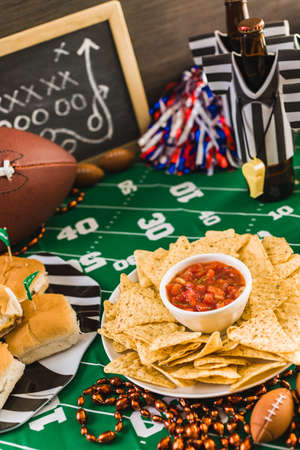 Game day football party table with beer, chips and salsa.の写真素材