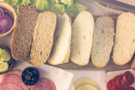Step by step. Fresh sub sandwich on white and wheat hoagies.の写真素材