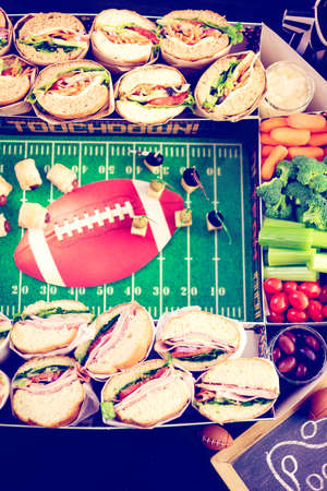 Football Snack Stadium filled with sub sandwiches, veggies and chips.の写真素材