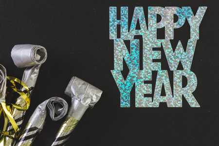 New Year Eve party blowouts on black board.