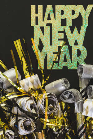 New Year Eve party blowouts on black board.の写真素材