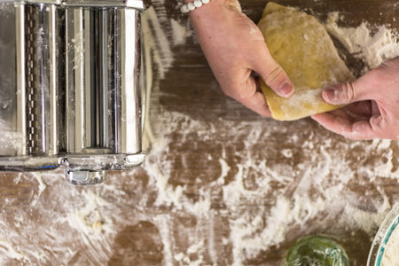 Preparing home made pasta with pasta maker.
