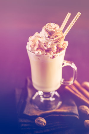 Traditional holiday drink egg nog garnished with whipped cream in the glass.の写真素材