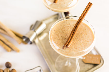 Holiday eggnog cocktail with dark rum and milk garnished with nutmeg.の写真素材