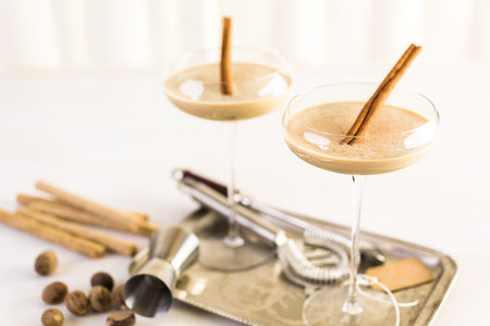Holiday eggnog cocktail with dark rum and milk garnished with nutmeg.
