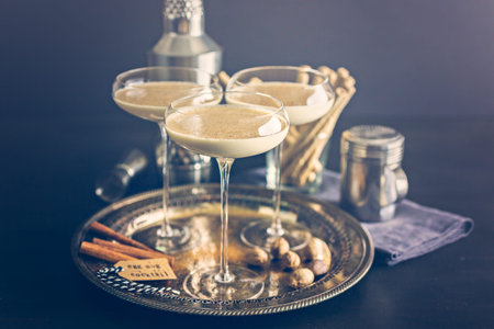 Egg nog cocktail in tall glasses on the tray at the minibar.の写真素材