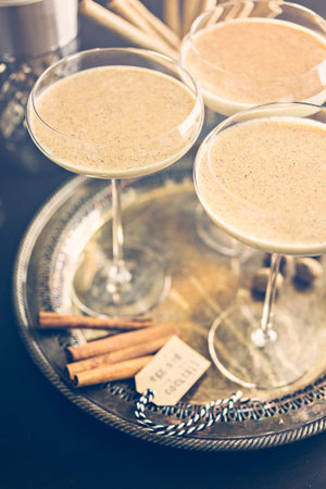 Egg nog cocktail in tall glasses on the tray at the minibar.の写真素材