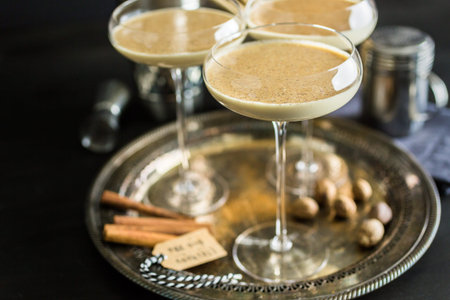 Egg nog cocktail in tall glasses on the tray at the minibar.の写真素材